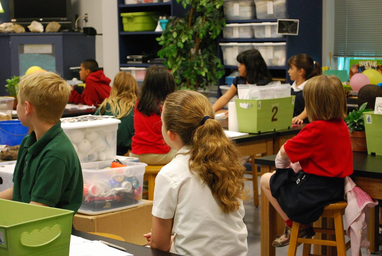 children listening to teacher in classroom
