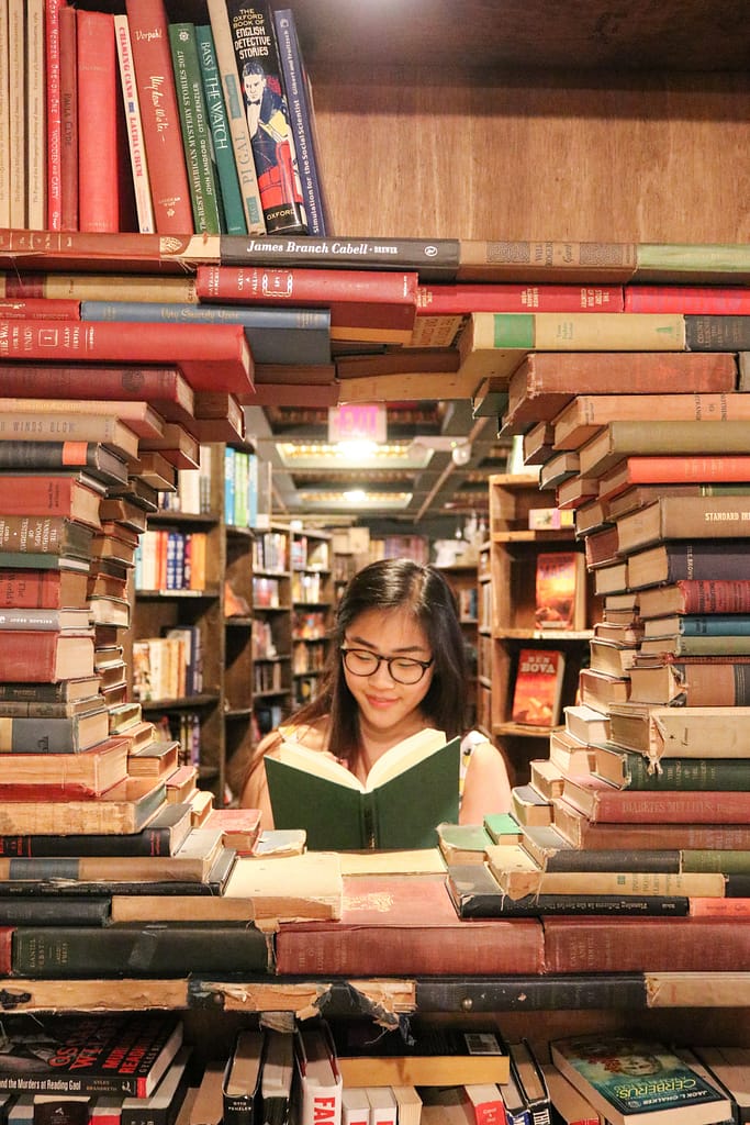 girl reading book in library